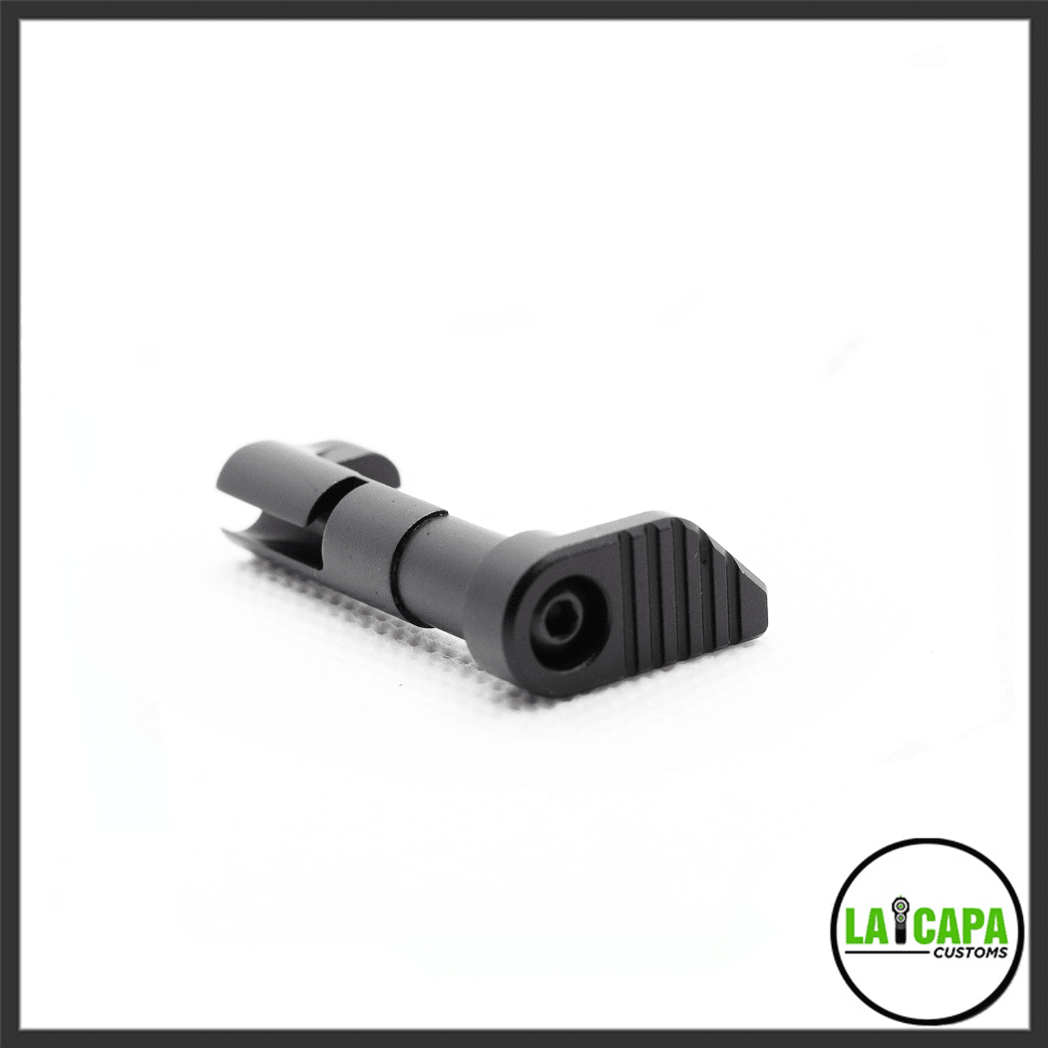 LA Capa Customs magazine catch in black, showing the ribbed paddle and pivot pin from a close angled view.