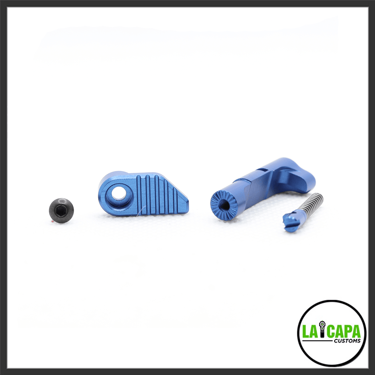 LA Capa Customs magazine catch in blue, shown disassembled with the catch body, lever arm, screw and spring laid out separately.