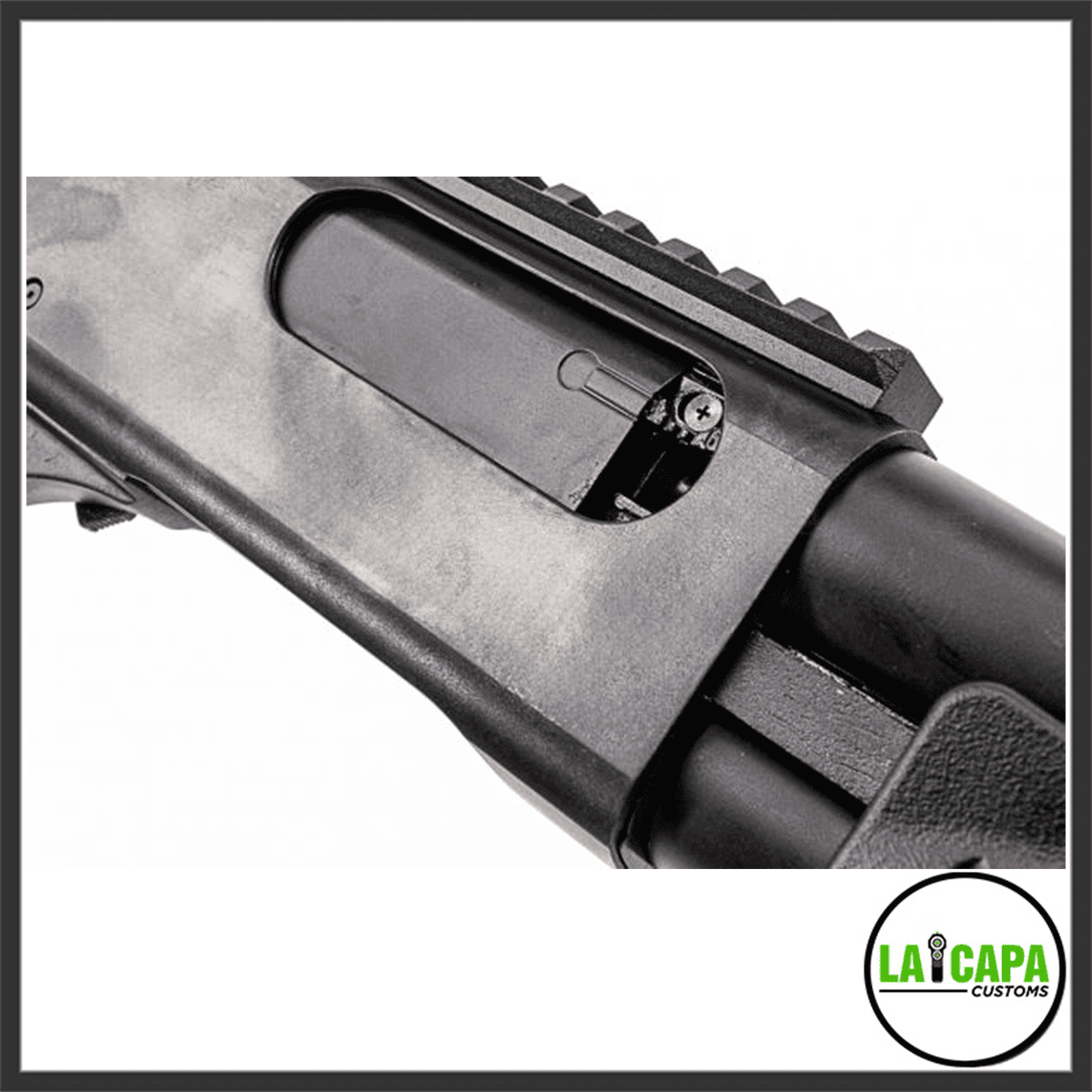 Close-up of the Tokyo Marui M870 Breacher receiver area showing the ejection port, barrel, and top Picatinny rail section.