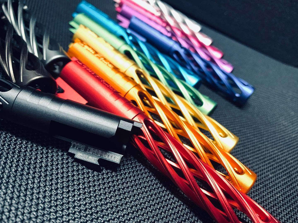 Dr. Black Type Dinging 0002 aluminum outer barrels fanned out in multiple anodised colours including red, orange, gold, teal, blue, purple and pink, with a grey barrel in the foreground.