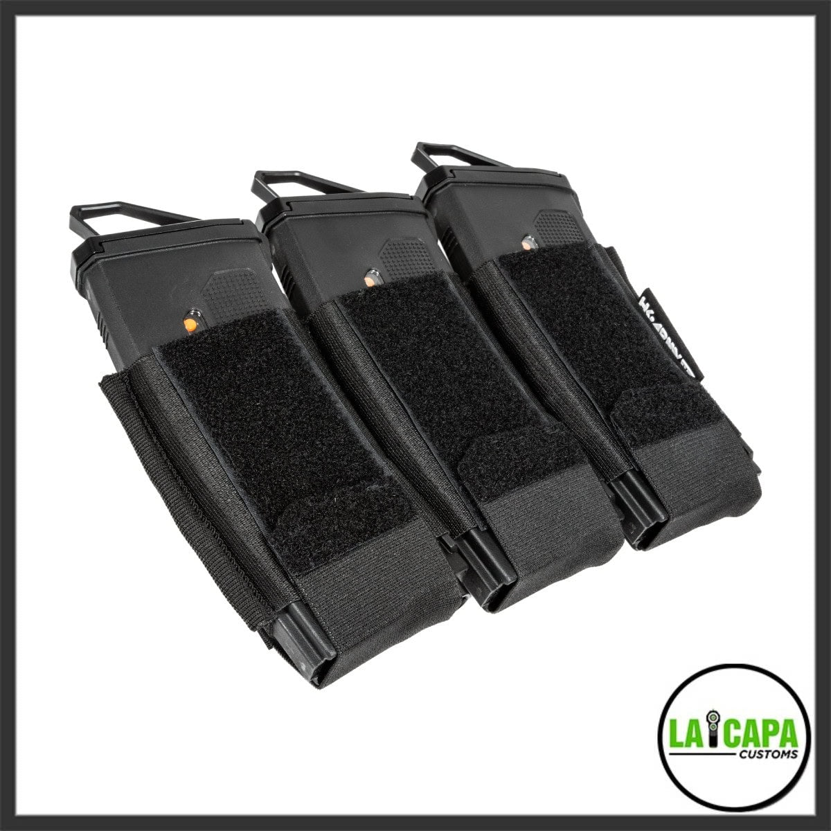 HK Army AR Mag Cell triple magazine pouch in black holding three airsoft M4 magazines with pull tabs extended, angled front view.