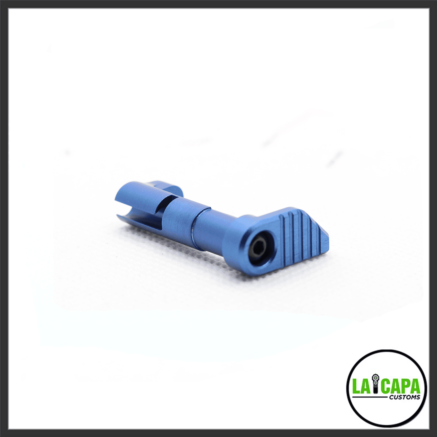 LA Capa Customs magazine catch in blue, showing the ribbed paddle and spring pin, angled view.