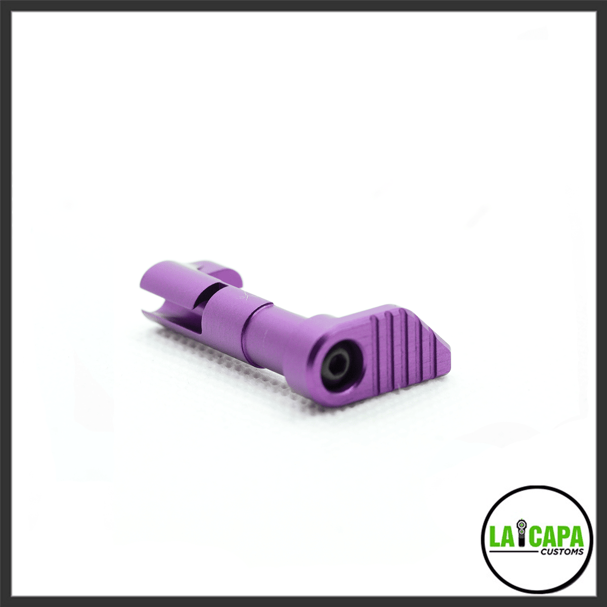 LA Capa Customs magazine catch in purple, showing the ribbed paddle and spring pin, angled view.
