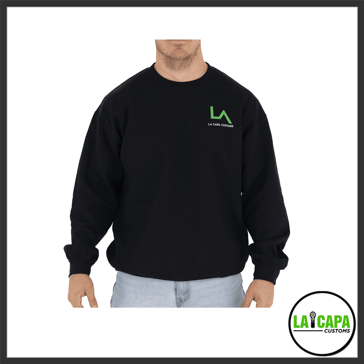 Man wearing a black LA Capa Customs crew-neck sweatshirt with a green LA logo on the left chest, front view.