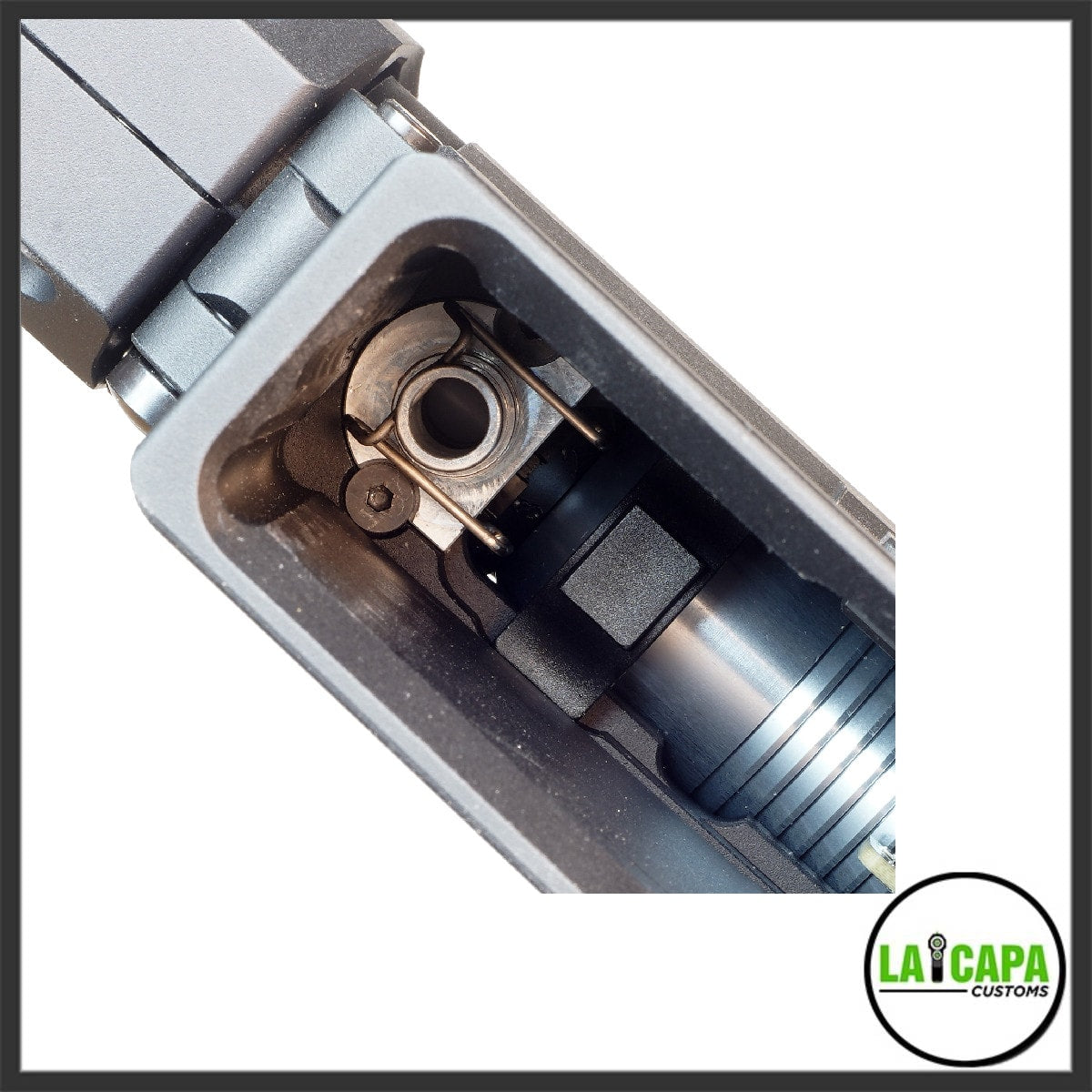 Close-up top-down view inside the MTW Billet Series Gen 3 magazine well showing the valve, spring and nozzle assembly detail.