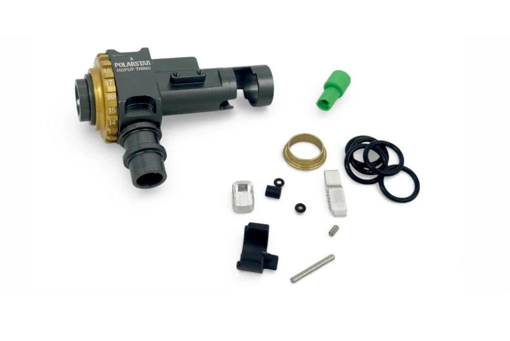Polarstar Hopup Thing unit with gold adjustment dial shown alongside its included spare parts: o-rings, nozzle tip, bucking, pins and small hardware.