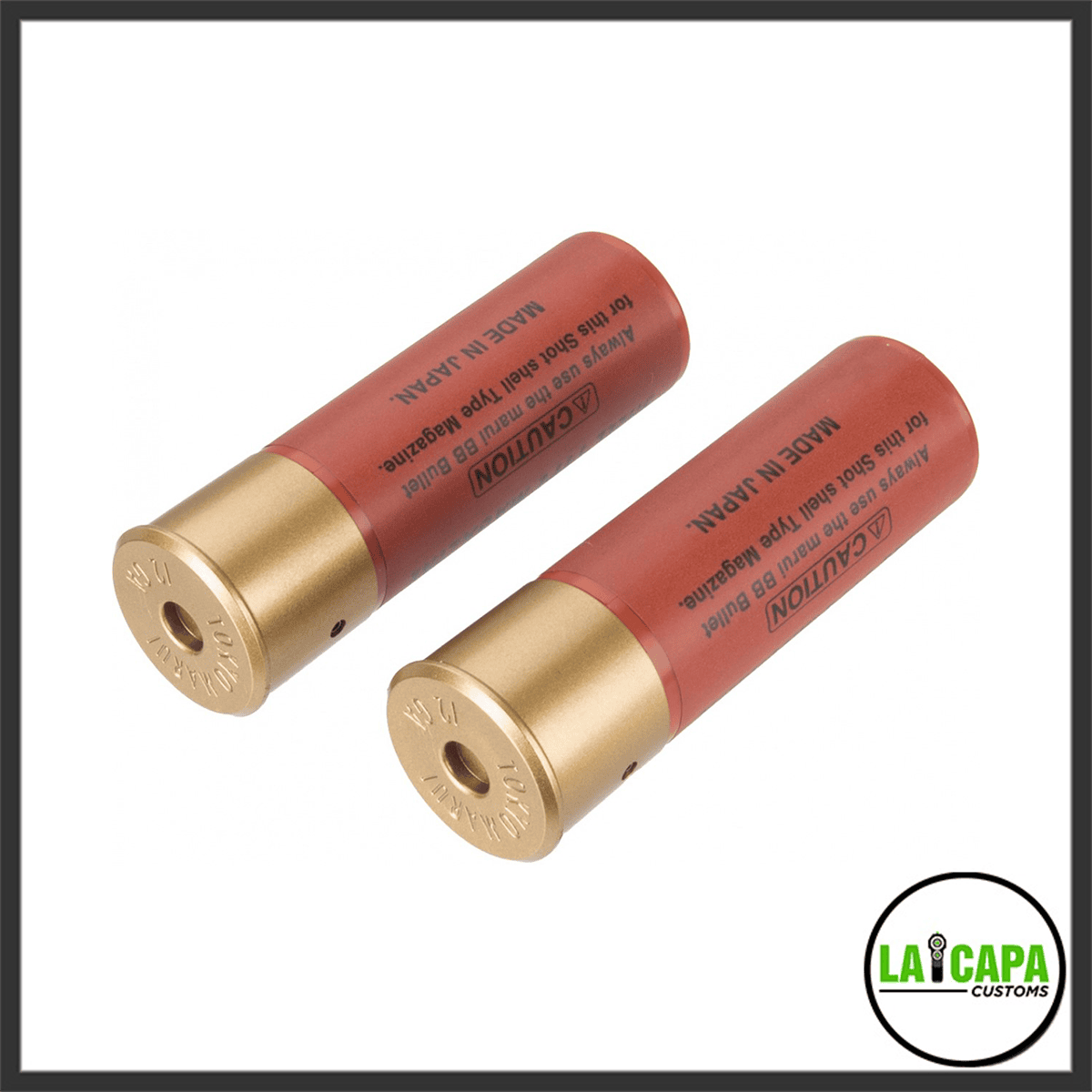 Two Tokyo Marui shotshell-type 30-round airsoft magazines in red with gold bases, printed with caution text and Made in Japan markings.